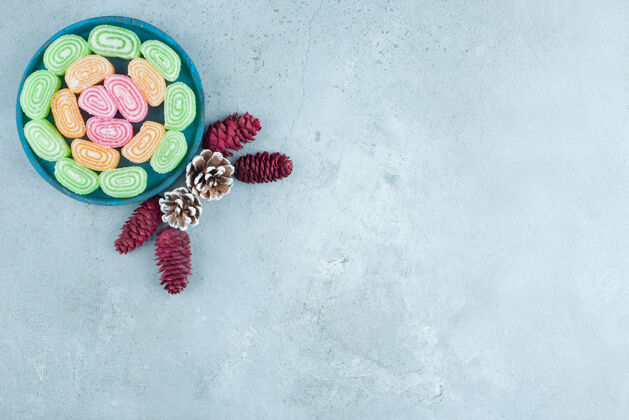 可口蓝色木板上的松果和水果糖果酱食物果冻水果