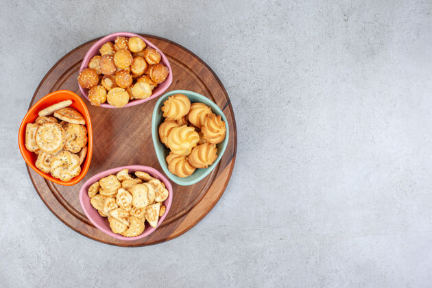 美味各种碗酥脆饼干和饼干片放在大理石表面的木板上美味碗美味
