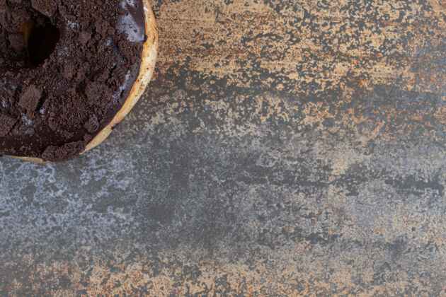 美味巧克力甜甜圈展示在大理石表面上衣巧克力美味