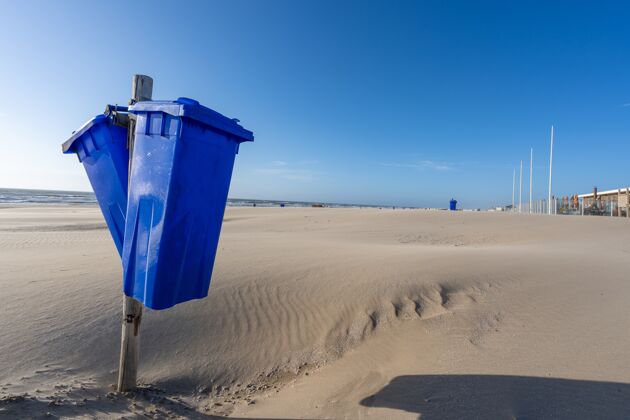 海岸日落时分海滩上垃圾箱的特写镜头阳光垃圾箱自然