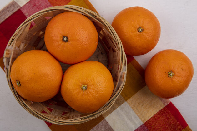 橙色顶视图橙色在一个白色背景的格子毛巾篮子毛巾彩色上衣