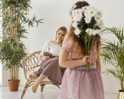 年轻小女孩拿着一束春花作为礼物送给妈妈女孩水平季节