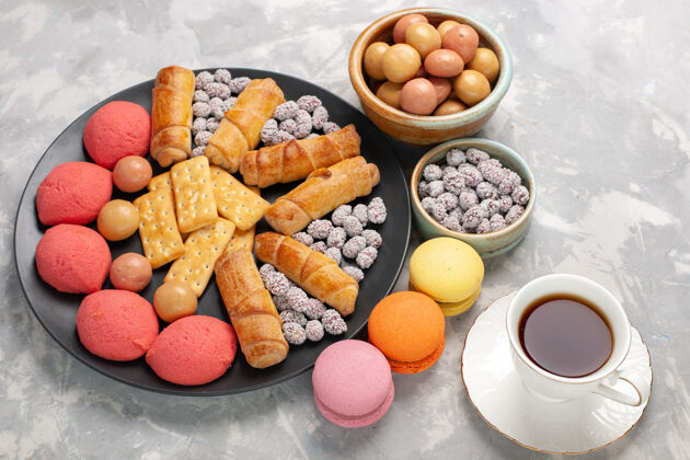 茶俯瞰美味的百吉饼蛋糕饼干糖果和茶浅白色办公桌蛋糕饼干饼干甜甜的糖派饼干水果糖果