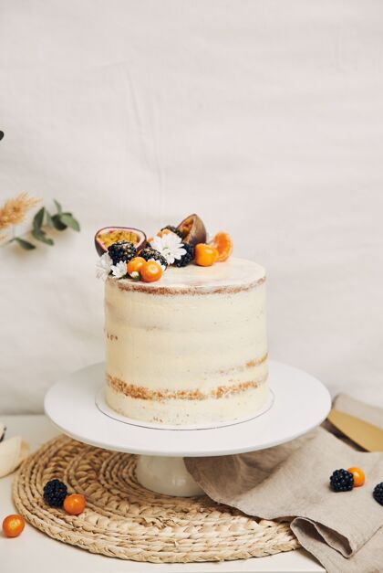 自制有浆果和西番莲的白色蛋糕 后面有植物水果新鲜派