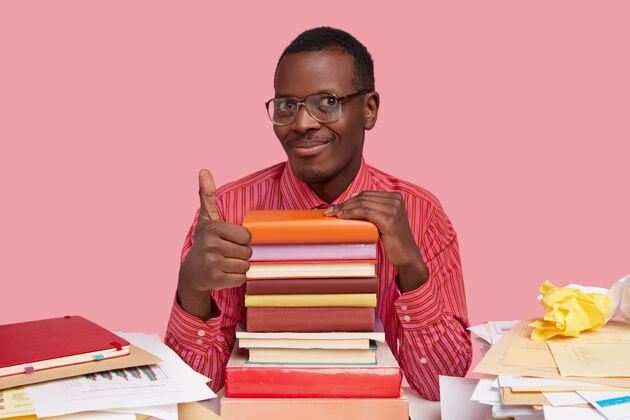 考试照片中英俊的非洲裔美国男子做了一个很好的手势 表示赞同 有着温柔的微笑批准书桌教科书