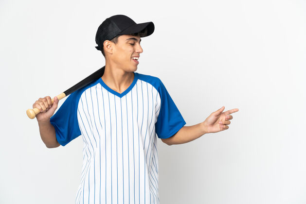 游戏在孤立的白色背景上打棒球的人用手指着侧面展示产品表情男性运动