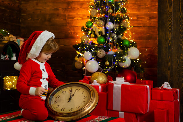 乐趣快乐的孩子在看圣诞老人的大钟帽子孩子正在等待新的一年圣诞节概念.假日.圣诞节孩子的梦想季节圣诞老人小