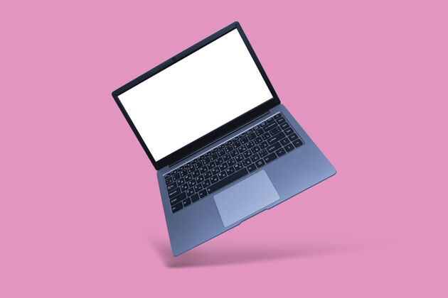 笔记本电脑纤薄的现代笔记本电脑 白色屏幕 粉色背景 带阴影屏幕阴影笔记本电脑