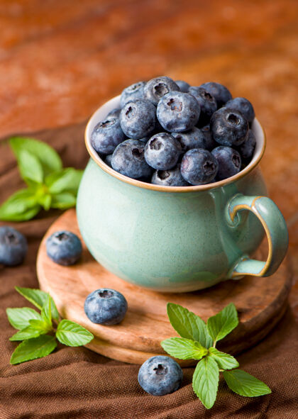 浆果一杯新鲜的蓝莓和薄荷叶薄荷桌子健康
