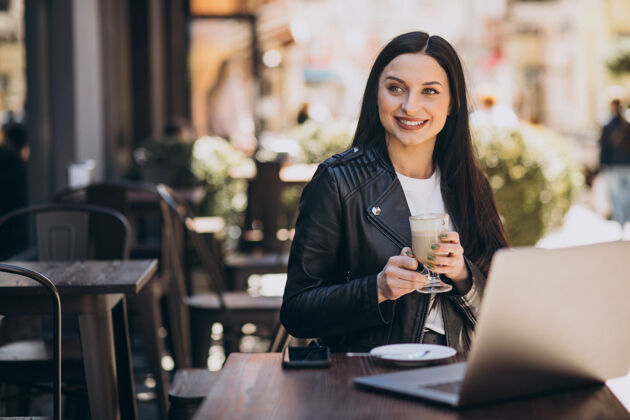 咖啡在咖啡馆里喝咖啡 用笔记本电脑工作的年轻女人城市人在线学习