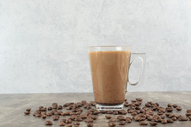 浓缩咖啡一杯热咖啡和咖啡豆放在大理石桌上卡布奇诺咖啡因豆子