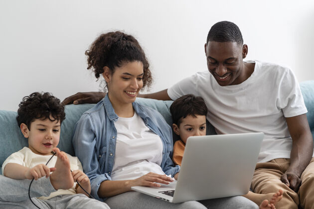 优质的时间快乐的黑人家庭一边看一边玩笔记本电脑上的东西爱熟悉父亲
