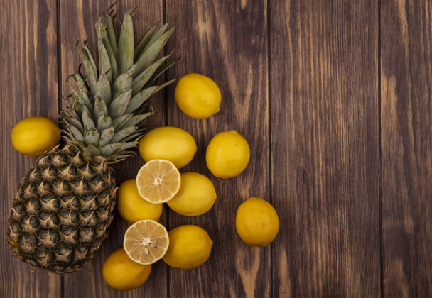 块顶视图健康的一半和整个柠檬与菠萝隔离在一个木制表面与复制空间饮食柠檬美味