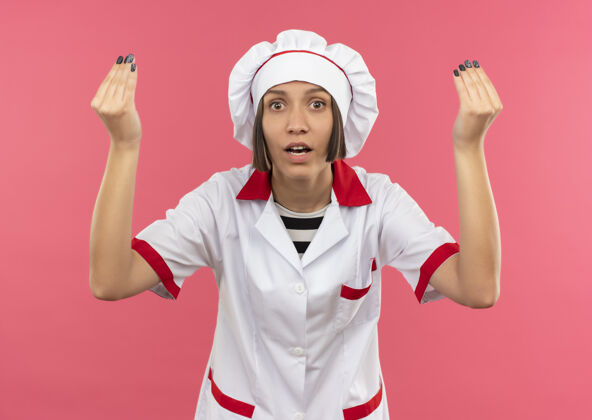 制服令人印象深刻的年轻女厨师在厨师制服做小费手势孤立的粉红色女性粉色印象
