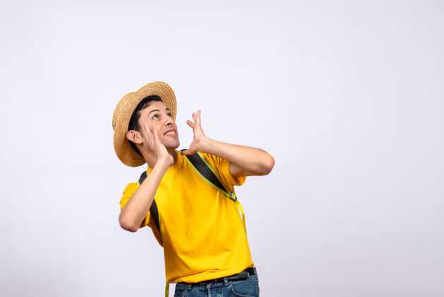 一个前视图激动的年轻人戴着帽子和黄色t恤人哑铃帽子