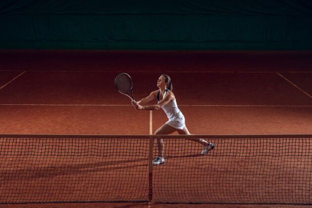 练习年轻的职业女运动员在运动场的墙上打网球动作女可爱