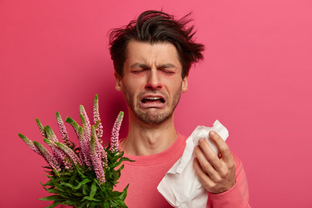 过敏感染者用组织擤鼻涕 春季出现过敏症状 呼吸不畅 不停地打喷嚏 拿着植物扳机 因感到厌倦治疗而哭泣免疫治疗概念组织疾病感冒