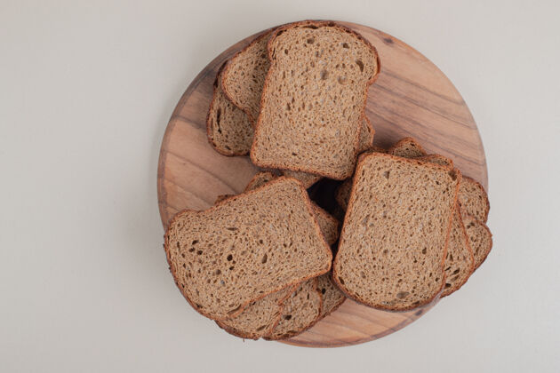 谷类把棕色面包片放在木盘上组餐面包