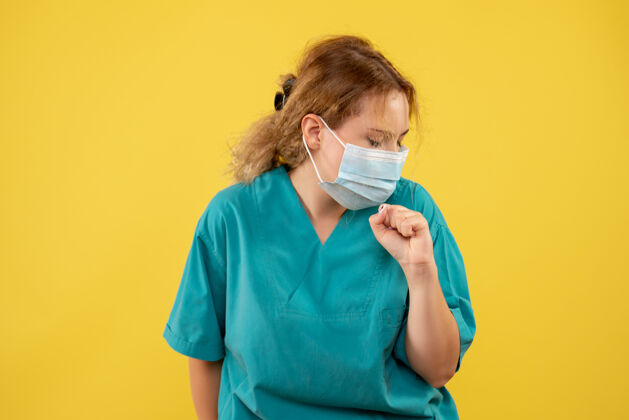 人黄墙上年轻女医生穿着医疗服 戴着口罩的正面图成人套装正面