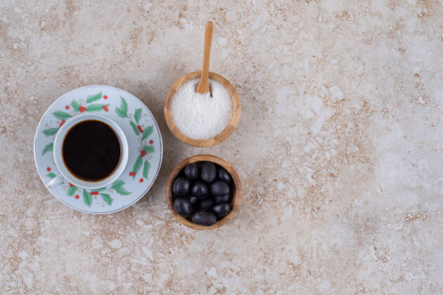 碗小碗糖和糖果旁边的一杯咖啡糖果芳香勺子