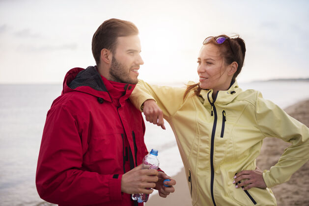 运动员特写适合年轻人在海边慢跑运动训练情侣夹克