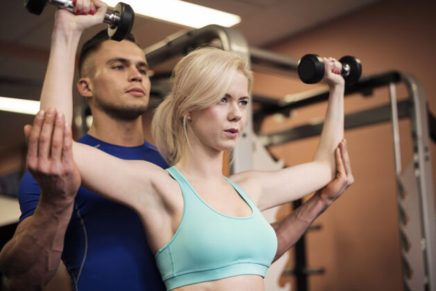 重量训练在女人的肩膀上努力工作努力女人锻炼