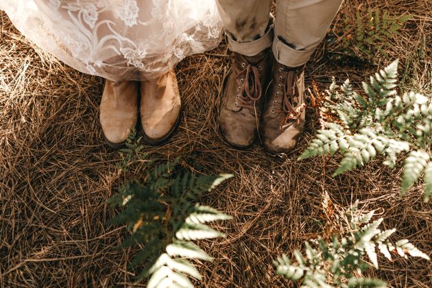 自然站在干草上的新郎新娘的旧鞋子的高角度镜头散步环境干草