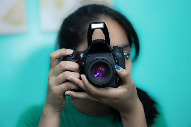 特写年轻的女摄影师用单反相机拍照年轻数码人