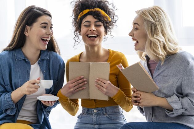 女人三个女人一起笑着看书全球快乐微笑