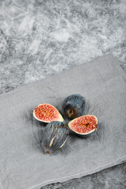 甜点用灰色桌布把成熟的无花果放在大理石表面切片紫菀天然