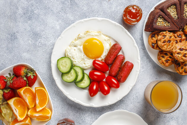 土耳其早餐盘子里有鸡尾酒香肠 煎蛋 樱桃番茄 糖果 水果和一杯桃子汁零食有机蔬菜