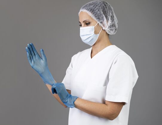 医学戴手套的中枪女人护理口罩专业