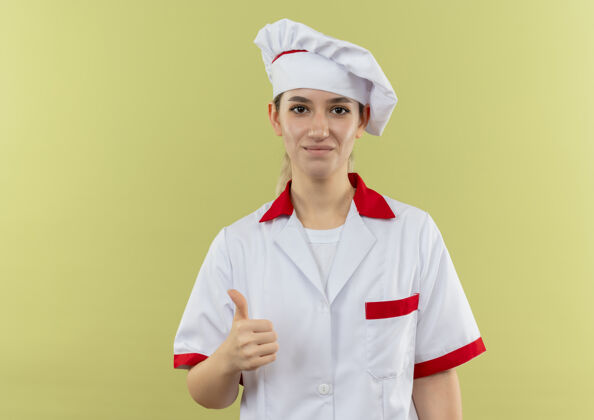 拇指年轻漂亮的厨师穿着厨师制服 在绿色的空地上露出大拇指空间厨师年轻