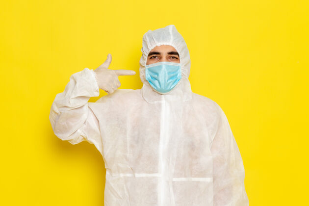 医疗身穿白色防护服 戴着黄色面罩的男性科学工作者的正面图特殊防护男性