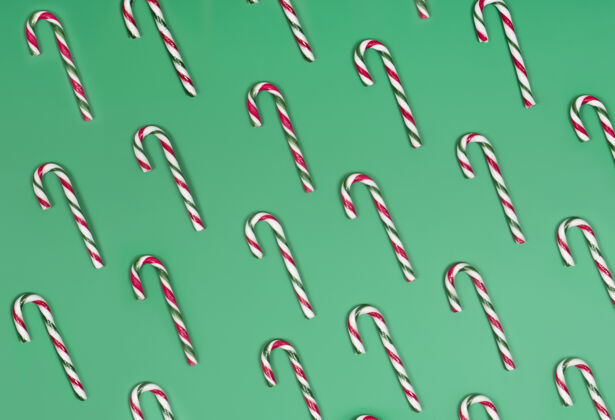 糖果绿色背景上的糖果手杖美味节日庆祝