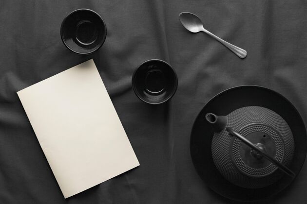平铺带茶壶和勺子的深色碗的俯视图餐具陶器水平