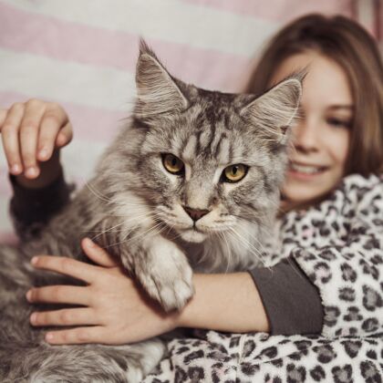 女性女孩和猫坐在床上快乐可爱小猫