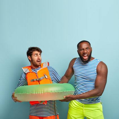 非洲暑假概念两个男人不能分享充气游泳圈的镜头愤怒的黑皮肤男人要求海滩救生员提供游泳设备非洲充气娱乐