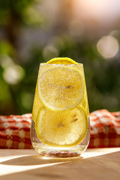 新鲜柠檬水和新鲜的柠檬在玻璃上花园上的模糊花园Diy水果户外