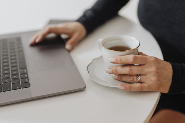键盘带着一杯茶和一台笔记本电脑的女人椅子饮料博客
